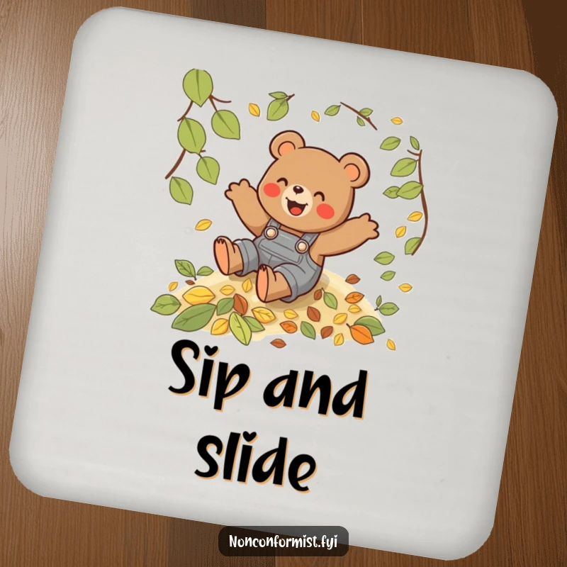Funny drink coaster featuring a playful bear in overalls sliding down a hill of autumn leaves.