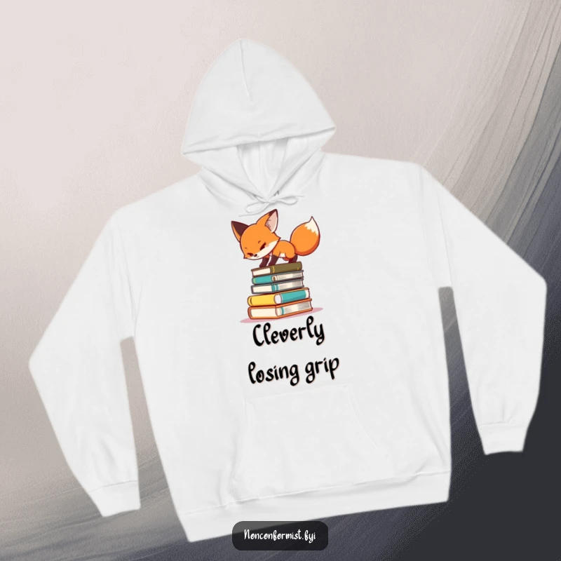 Funny hoodie featuring a determined fox balancing precariously on a towering pile of books, illustrating intellectual effort.