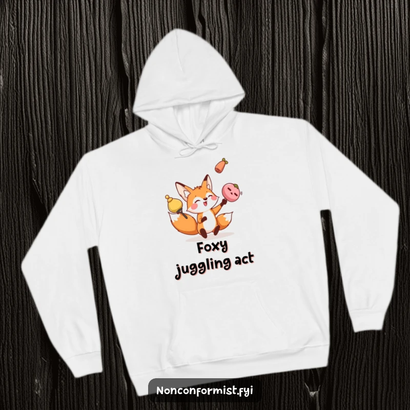 Funny fox hoodie with a playful character juggling oddly shaped objects, symbolizing skillful multitasking and warmth.