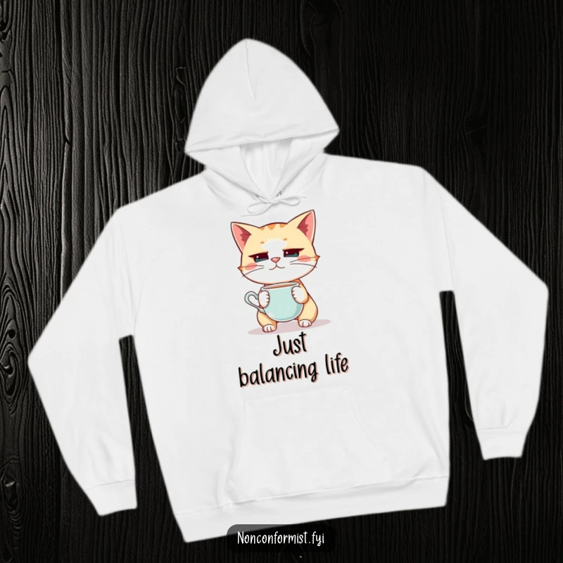 Funny Cat Hoodie: A quirky cat balancing a teacup on its nose with extreme focus, an amusing and cozy apparel item.
