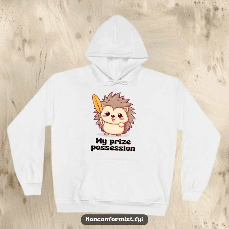 Funny hoodie depicting a cheerful hedgehog character holding a vibrant feather, radiating quiet pride and charm.