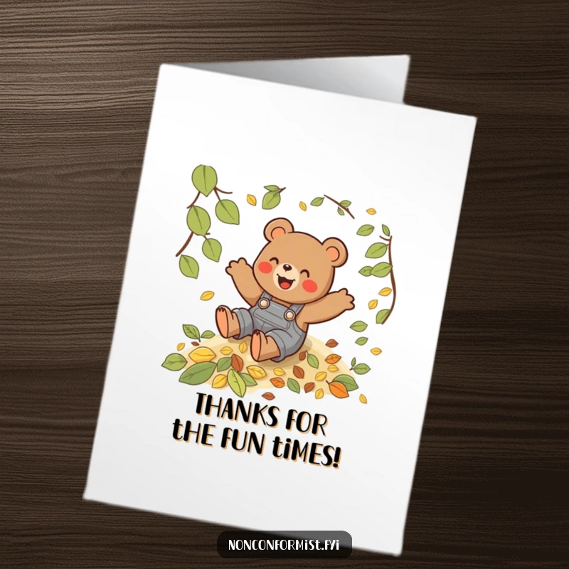 Funny free printable thank you card: a bear in overalls gleefully slides down a hill of leaves, sending thanks.